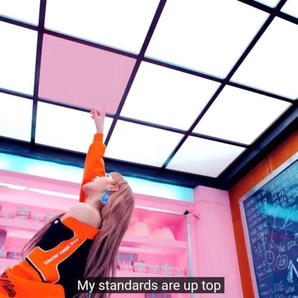 Lisa pointing up at the pink square tile, as in SQUARE UP the album